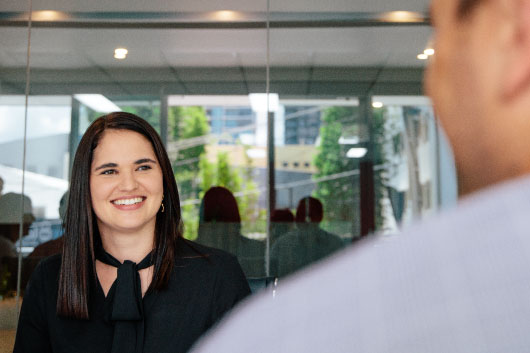 Communications professional smiling in meeting