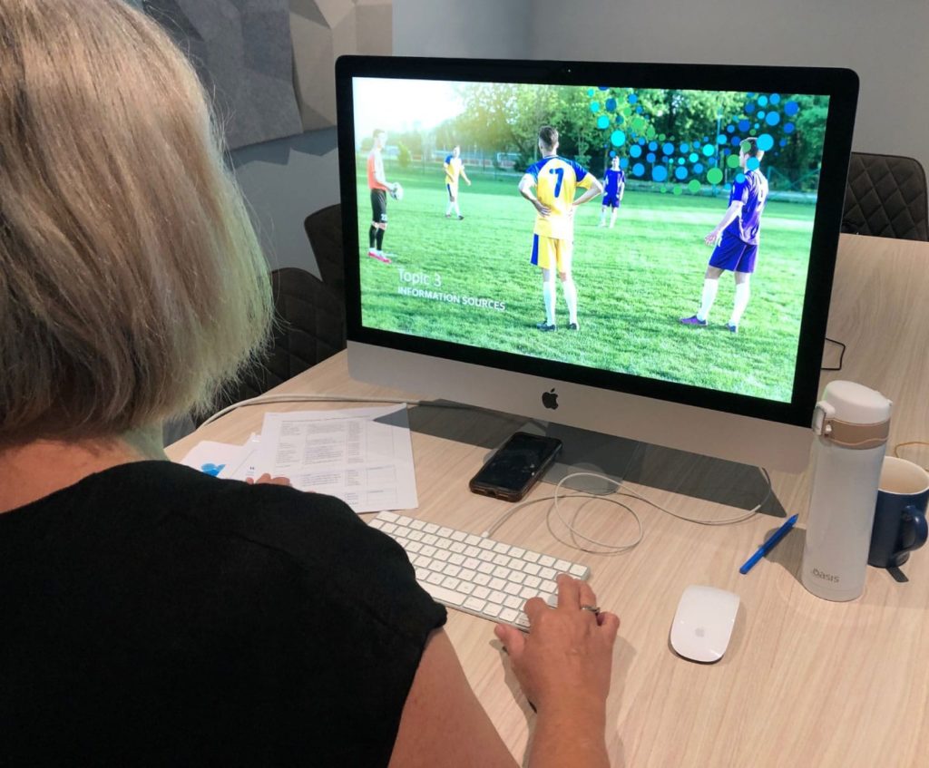 Communications professional looking at computer screen